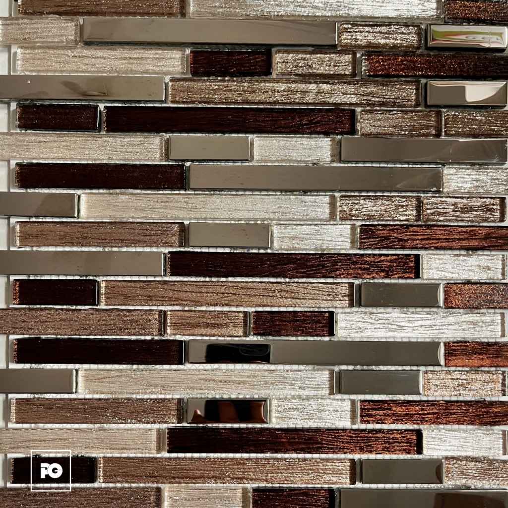 Close-up of a brown-toned glass and ceramic brick-pattern backsplash with metallic accents and glossy surfaces